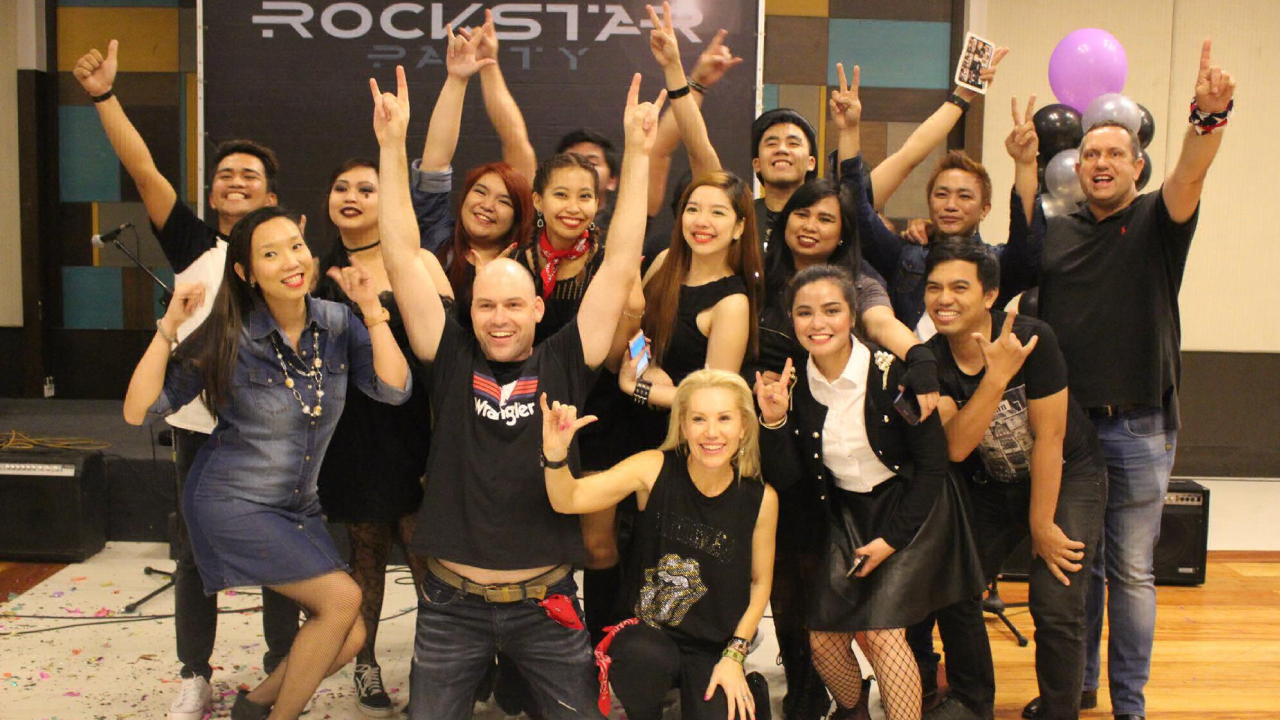 Photo of Beepo employees at the year end party themed Rock and Roll.